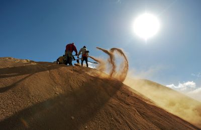 shoveling sand in Sahara